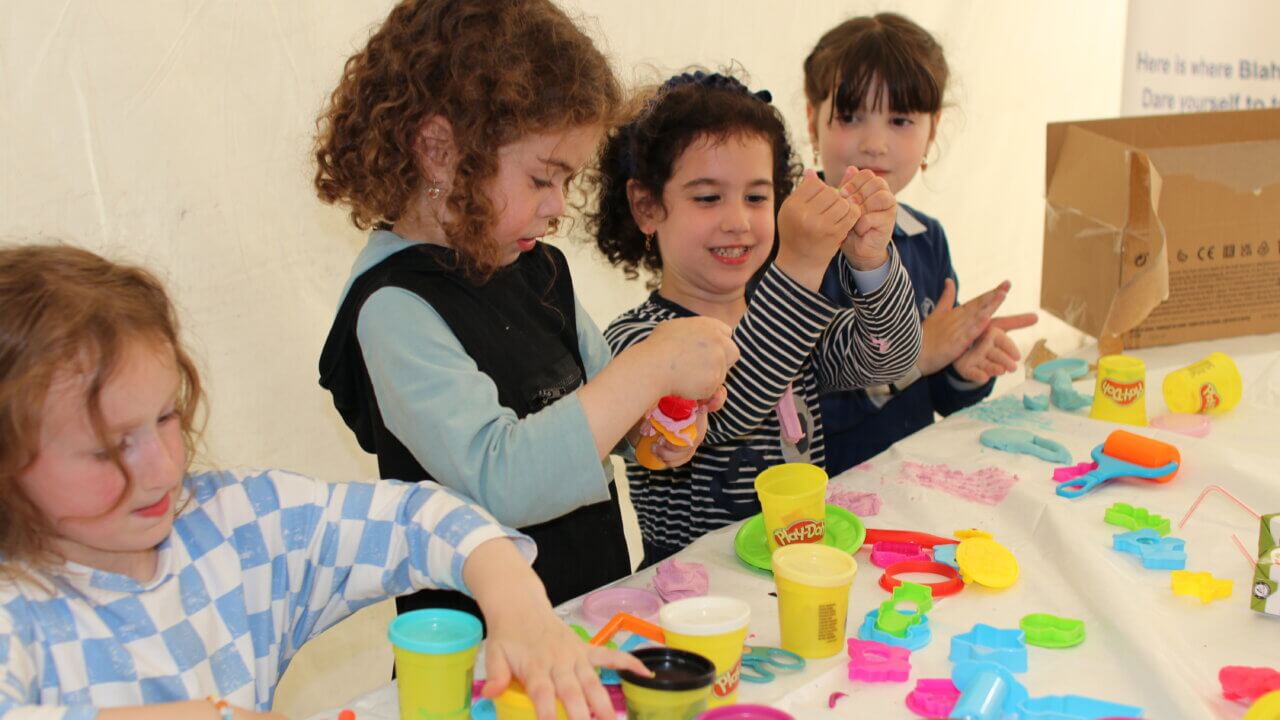 A group of children playing at a Young and Inspired activity club, funded by Cash for Kids